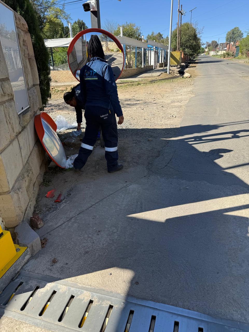 TP Technologies team installing a convex safety mirror